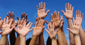 hands raised to volunteer