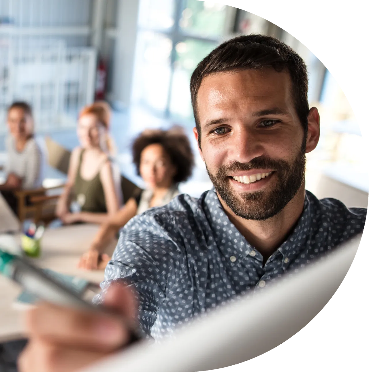 Agile for Project Managers hero image – man writing on a white board in front of a team meeting
