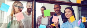 Reimagining Agility Initiative Banner – Agile team working with post its